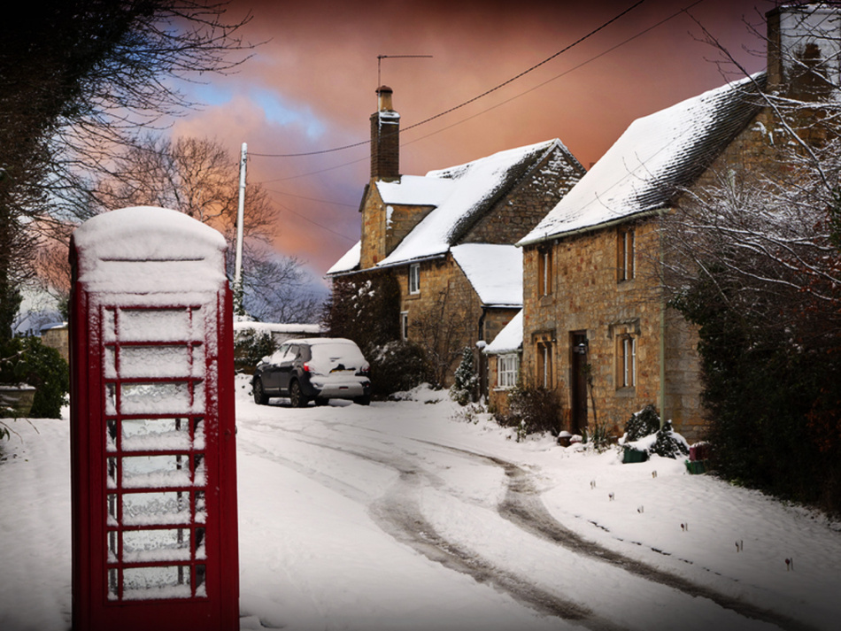 a snowed road with houses